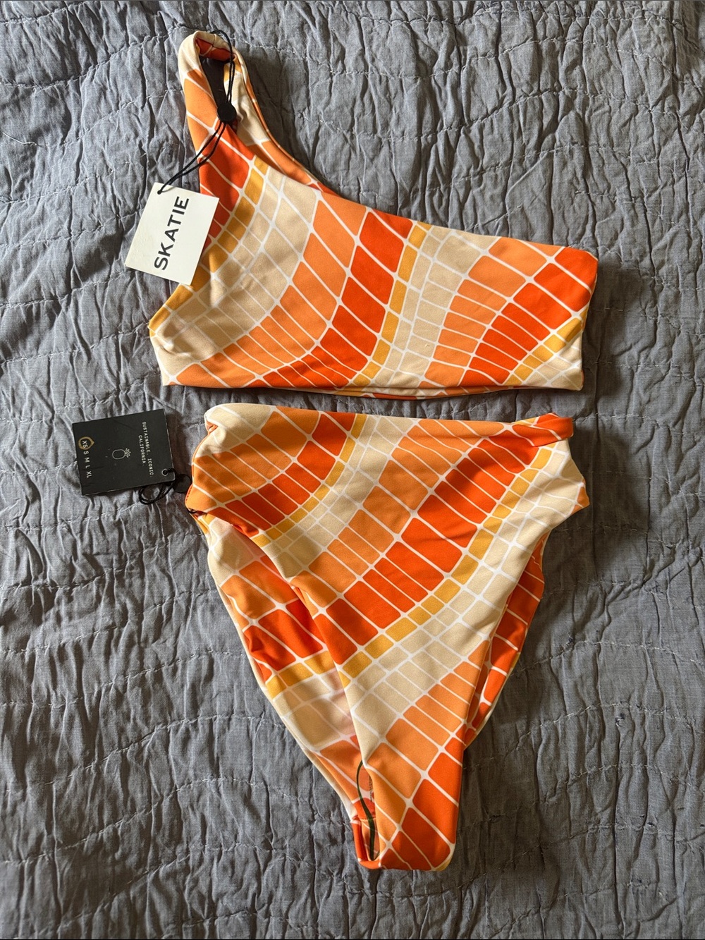 Skatie Asymmetrical Two-Piece Swimsuit in Orange and Cream Tile Print